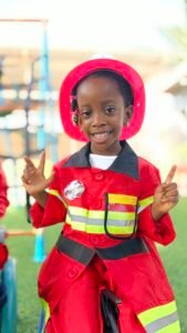 Child dressed in a firefighter costume at Brainy Explorers Montessori