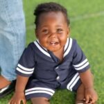 Toddler smiling outdoors at Brainy Explorers Montessori