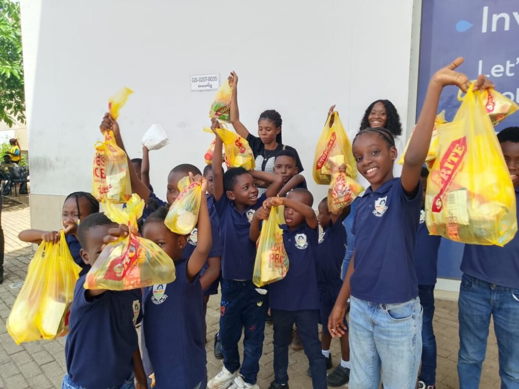 Pupils holding shopping bags on a field trip to Shoprite
