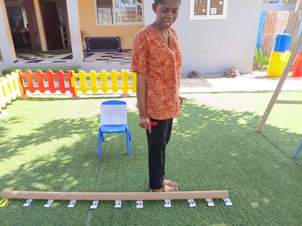 Teacher leading an outdoor number-line addition lesson